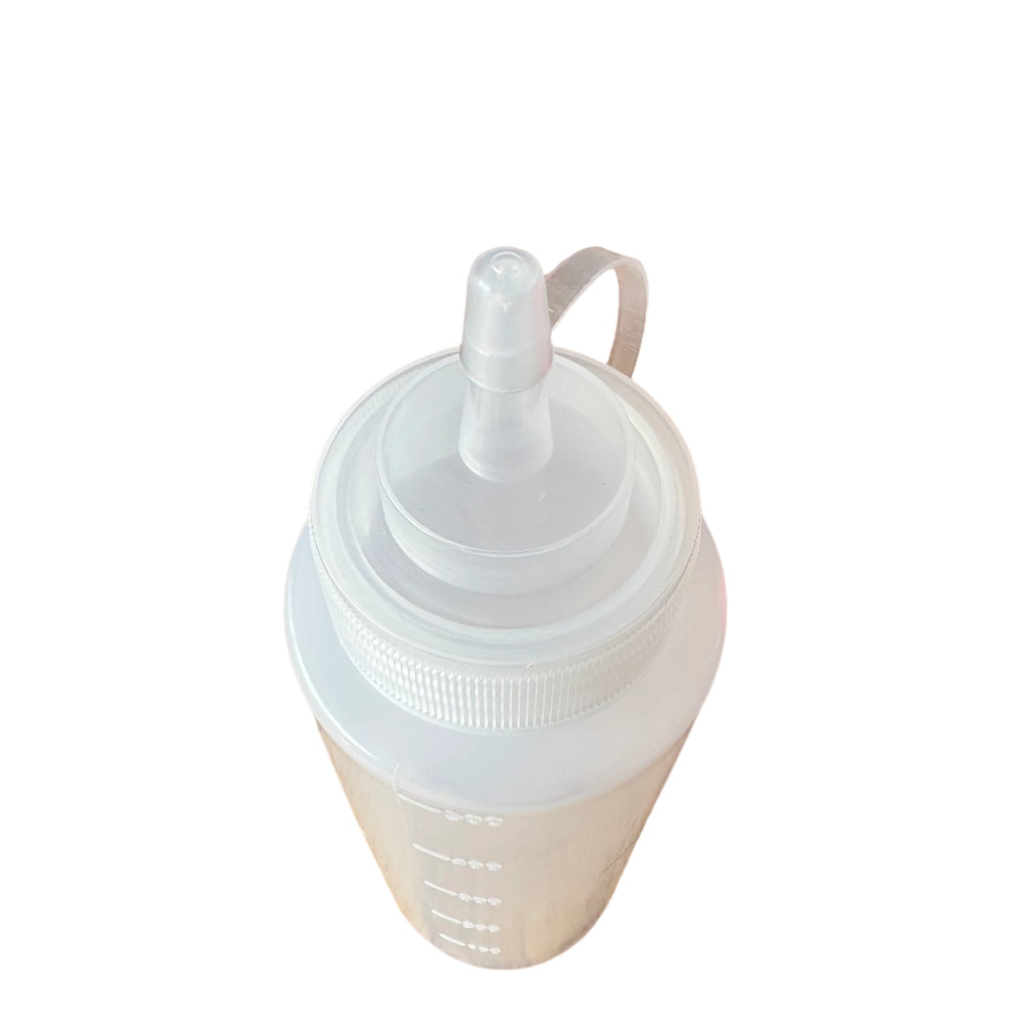 White silicone bottle with a cap on a wooden surface